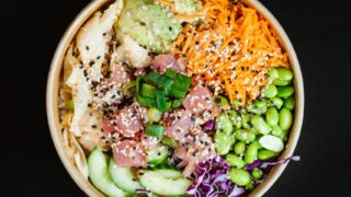 poke bowl: fish, rice, edamame, carrots, avocado, ginger, green onions, cabbage