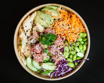 poke bowl: fish, rice, edamame, carrots, avocado, ginger, green onions, cabbage