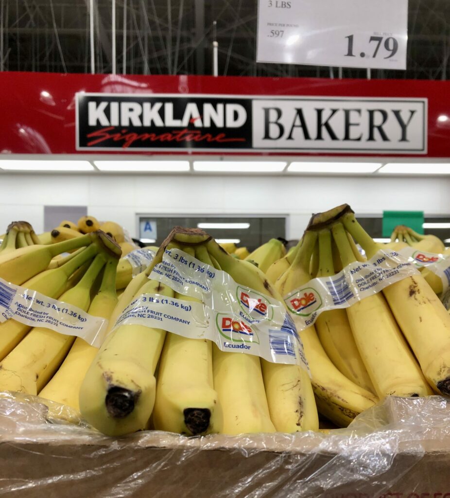 COSTCO Wholesale Kirkland Bakery sign behind bananas