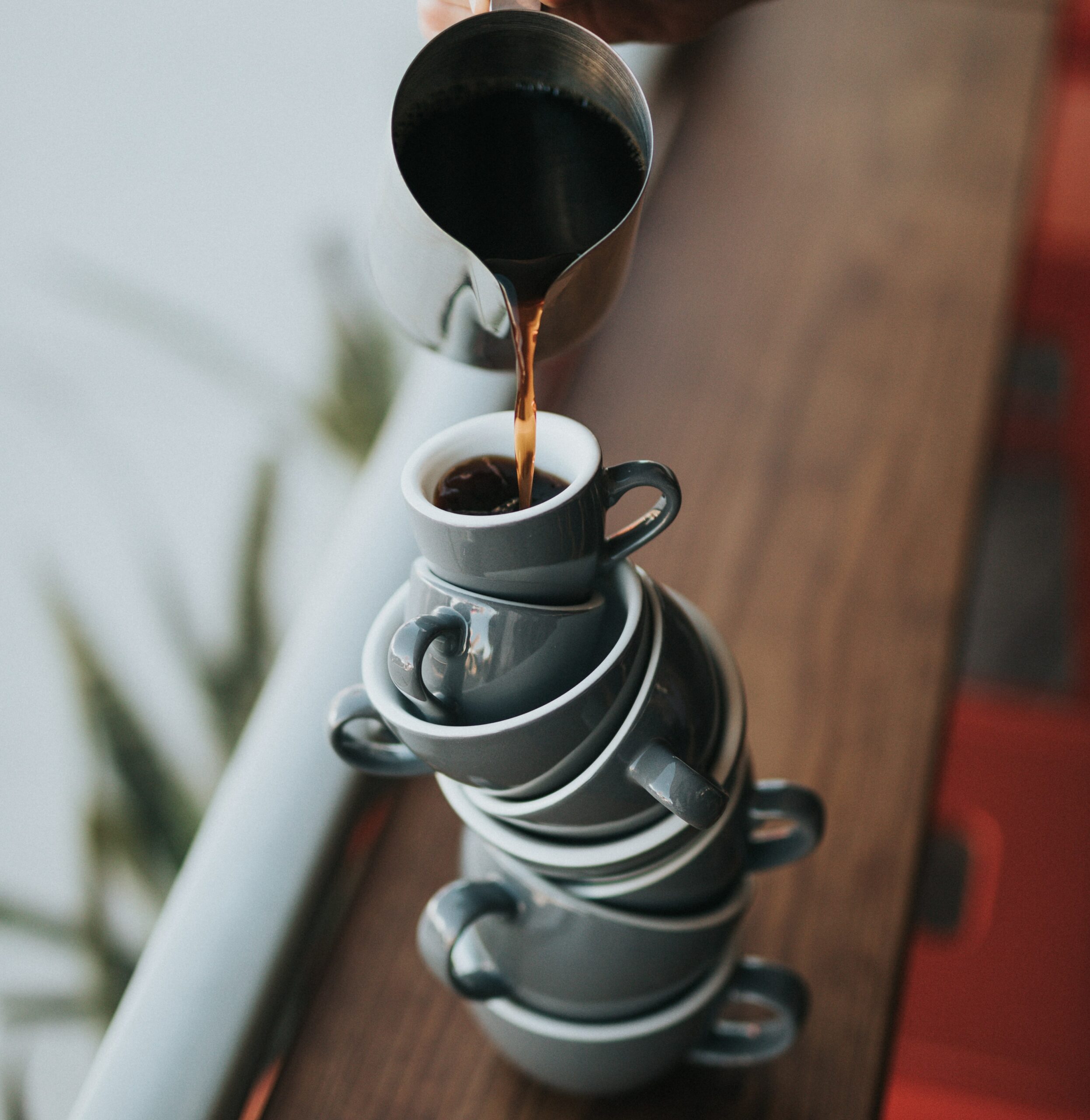 pouring coffee into mugs that are balancing: work-life balance